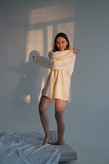 Woman doing a graceful and comfortable stretching pose in a bright cozy room